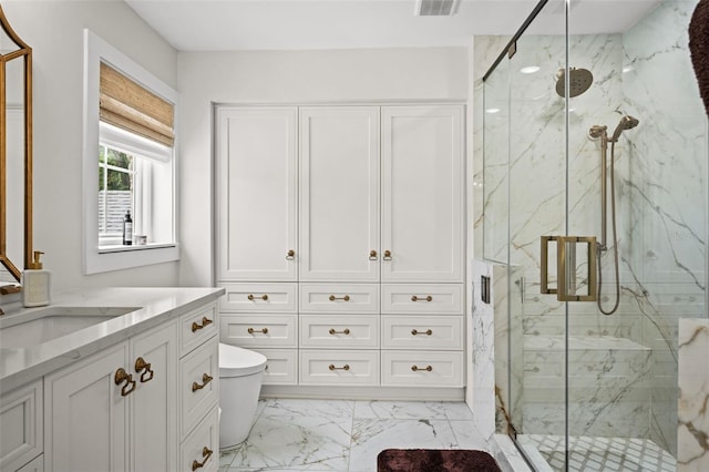 bathroom with vanity, toilet, and an enclosed shower