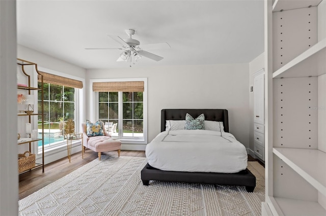 bedroom with light wood-type flooring and ceiling fan