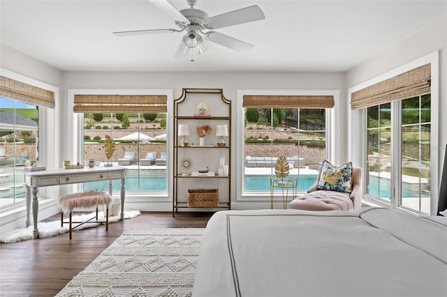 bedroom with dark hardwood / wood-style floors and ceiling fan