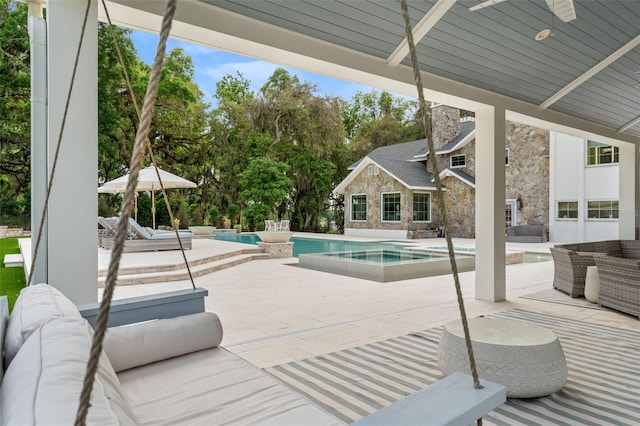 view of swimming pool with an outdoor living space, an in ground hot tub, and a patio