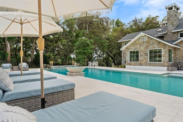 view of swimming pool featuring a patio area