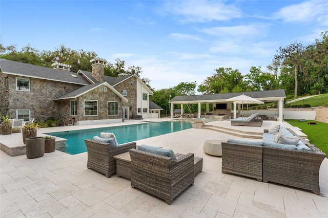 view of pool with outdoor lounge area and a patio area