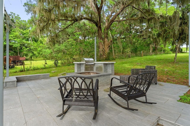 view of patio featuring an outdoor kitchen and a grill