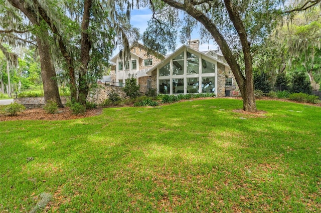 view of yard featuring a sunroom