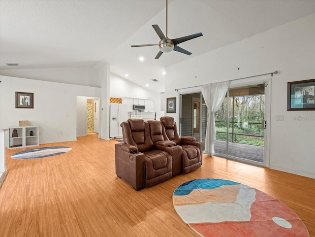 living room featuring ceiling fan, high vaulted ceiling, and light hardwood / wood-style flooring