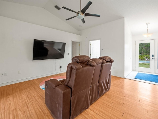 living room with light hardwood / wood-style floors, ceiling fan, and lofted ceiling