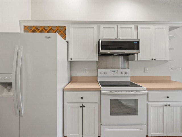 kitchen with white cabinets and white appliances