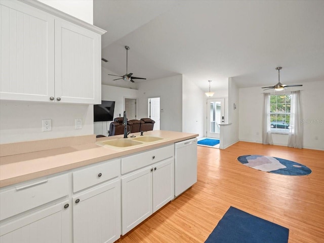 kitchen with dishwasher, sink, pendant lighting, white cabinets, and light wood-type flooring