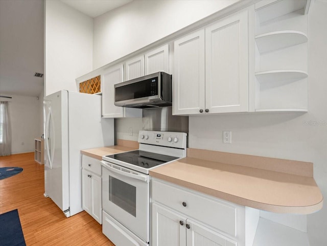 kitchen featuring white cabinets, white appliances, and light hardwood / wood-style flooring