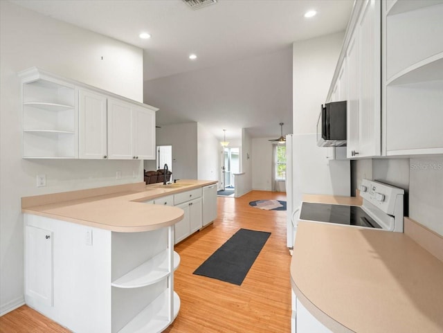 kitchen featuring white cabinets, kitchen peninsula, light hardwood / wood-style flooring, ceiling fan, and range