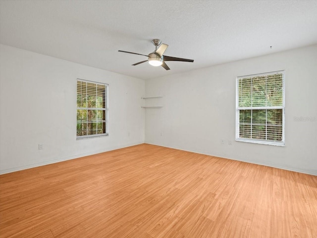 spare room with ceiling fan and light hardwood / wood-style floors