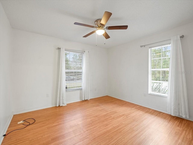 spare room with ceiling fan and light hardwood / wood-style floors