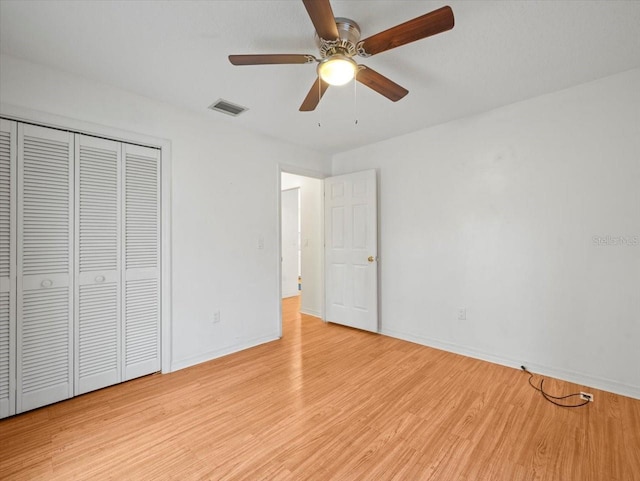 unfurnished bedroom featuring a closet, ceiling fan, and light hardwood / wood-style flooring