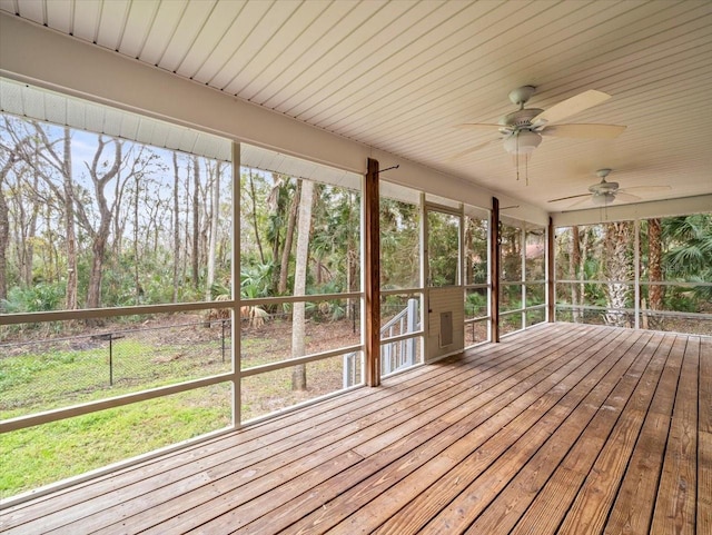 unfurnished sunroom featuring ceiling fan