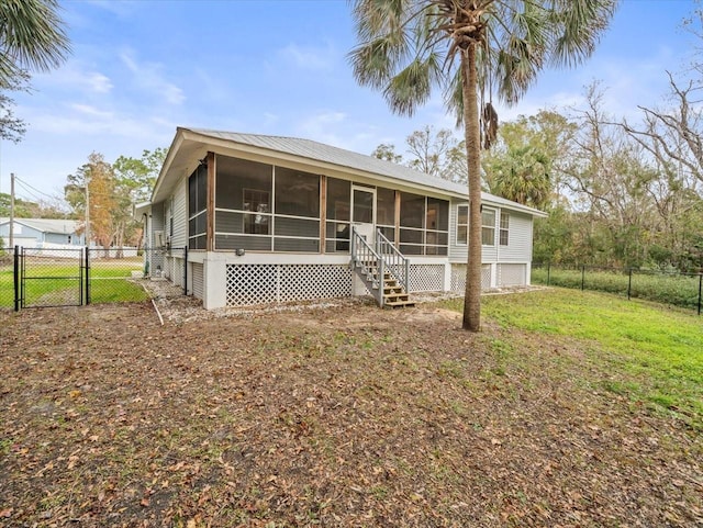 view of front of property with a front lawn and a sunroom