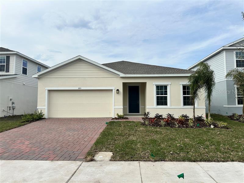 view of front facade with a front lawn and a garage