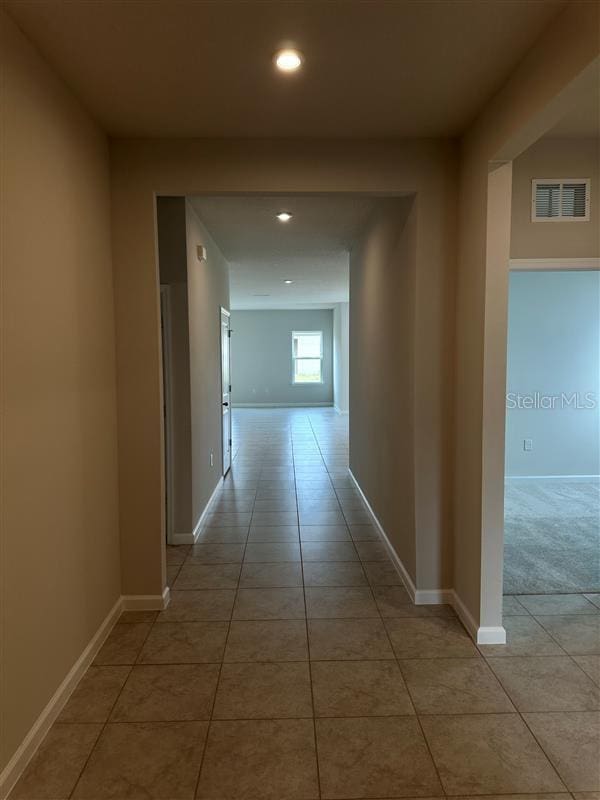 corridor with light tile patterned flooring