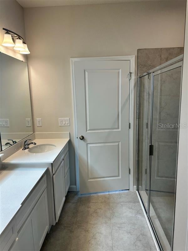 bathroom with walk in shower and vanity