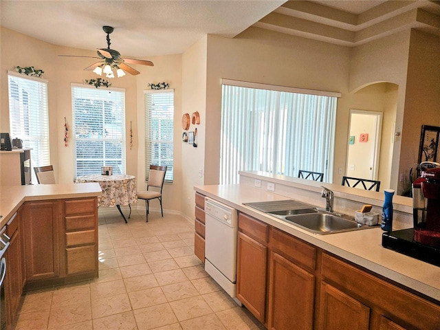 kitchen featuring white dishwasher, ceiling fan, light tile patterned floors, and sink