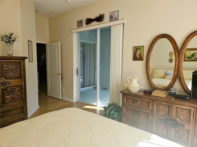 bedroom featuring hardwood / wood-style floors and access to outside