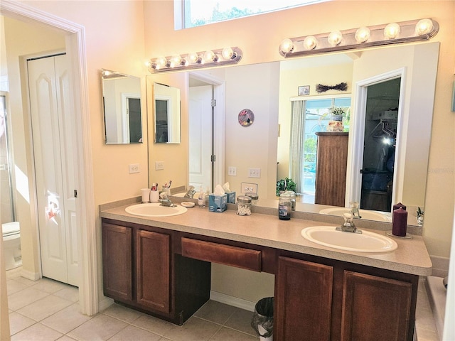 bathroom featuring tile patterned flooring, vanity, and toilet