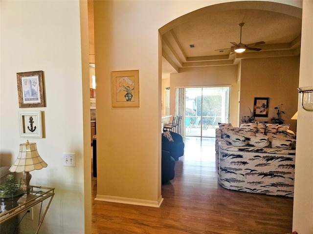 hallway featuring hardwood / wood-style flooring and a tray ceiling