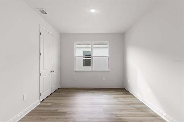 spare room featuring light wood-type flooring