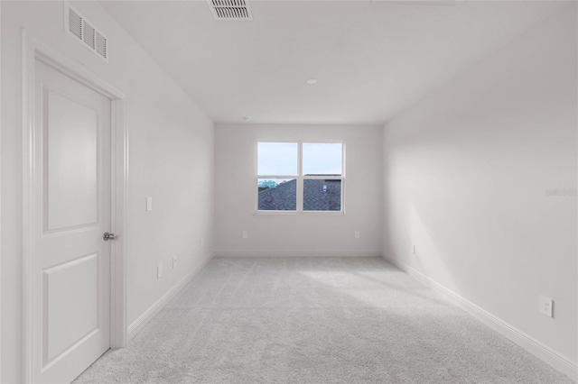 unfurnished room featuring light colored carpet