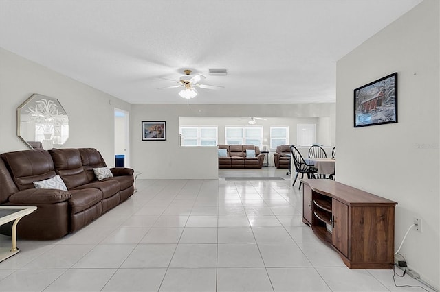 living room featuring light tile patterned flooring and ceiling fan