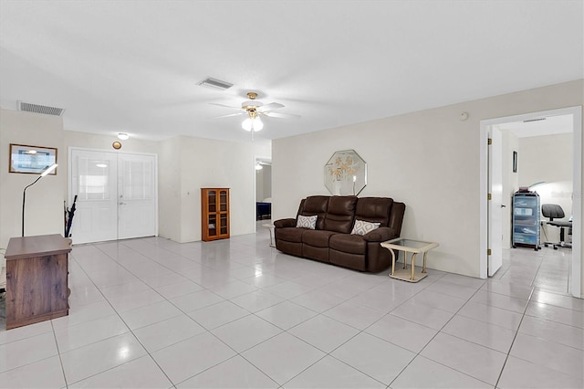 tiled living room with ceiling fan