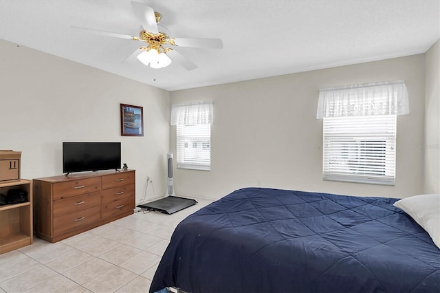 tiled bedroom featuring ceiling fan