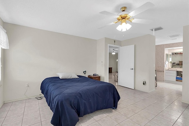 bedroom featuring ceiling fan, connected bathroom, and light tile patterned flooring