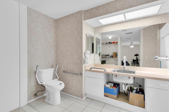 bathroom with sink, tile patterned flooring, toilet, and ceiling fan