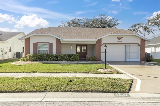 ranch-style home featuring a front yard, a garage, and central air condition unit