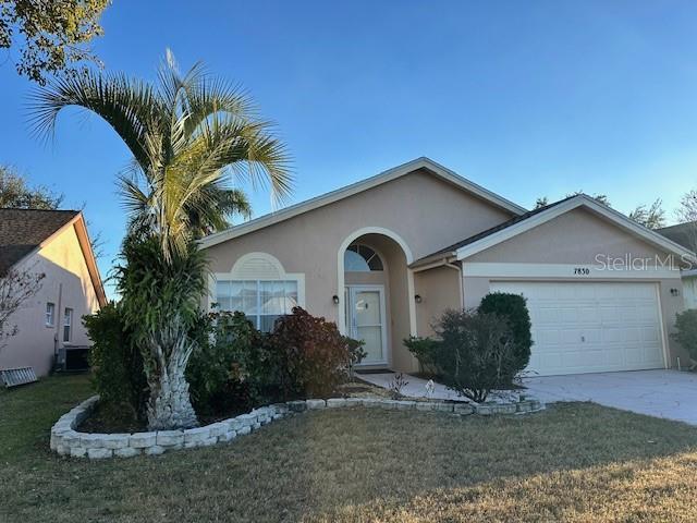 single story home with a front yard and a garage