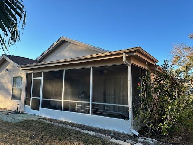 view of side of property featuring a sunroom