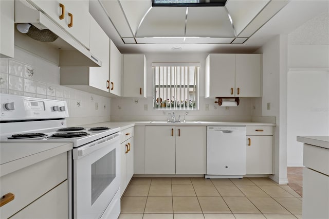 kitchen featuring white appliances, light countertops, a sink, and white cabinets