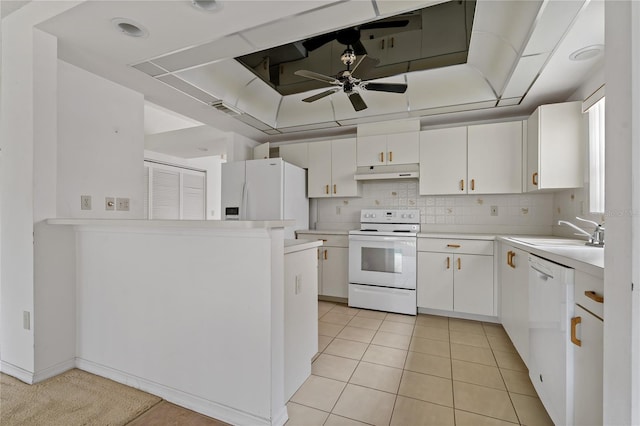 kitchen featuring light countertops, white appliances, white cabinetry, and a sink