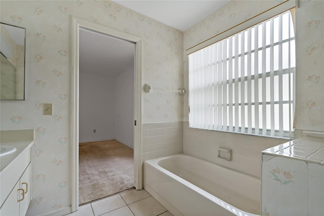 full bathroom with wallpapered walls, tile patterned flooring, a garden tub, and vanity