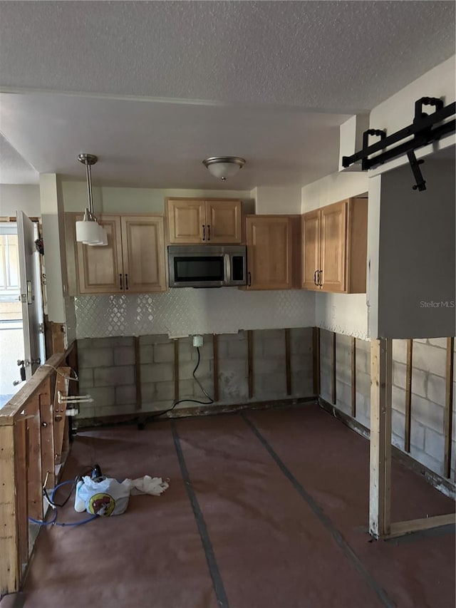 kitchen with pendant lighting and a textured ceiling