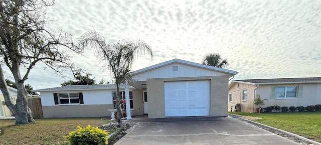 ranch-style house with a garage and a front lawn