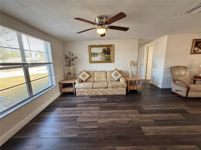 living room with ceiling fan and dark wood-type flooring