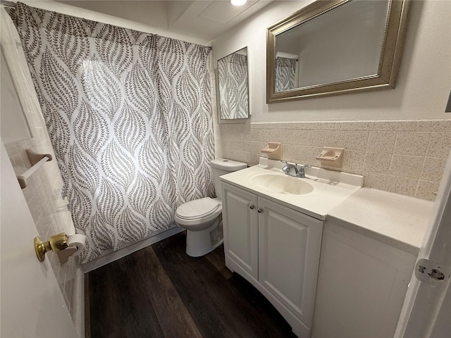 bathroom with hardwood / wood-style floors, vanity, and toilet