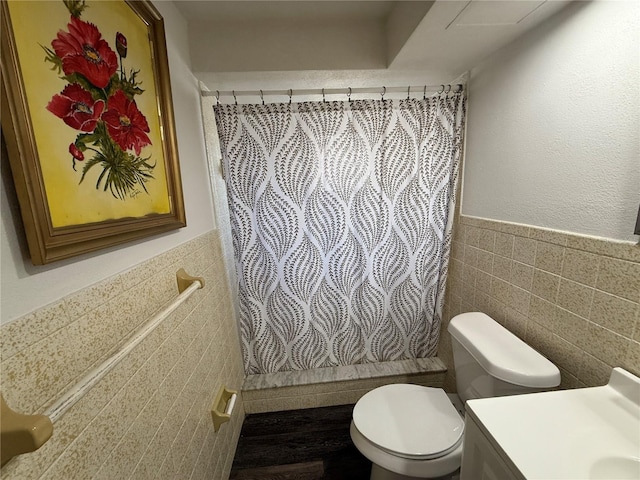 bathroom featuring tile walls, vanity, a shower with curtain, and toilet