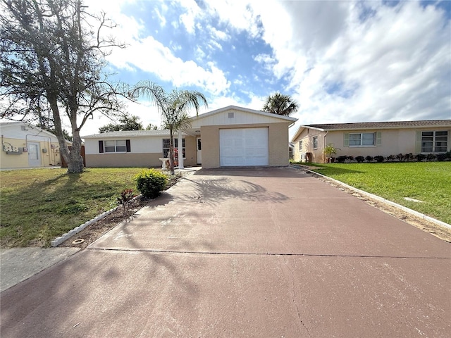 ranch-style house featuring a garage and a front lawn