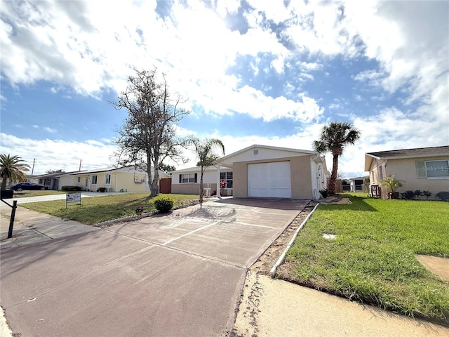 single story home featuring a garage and a front lawn