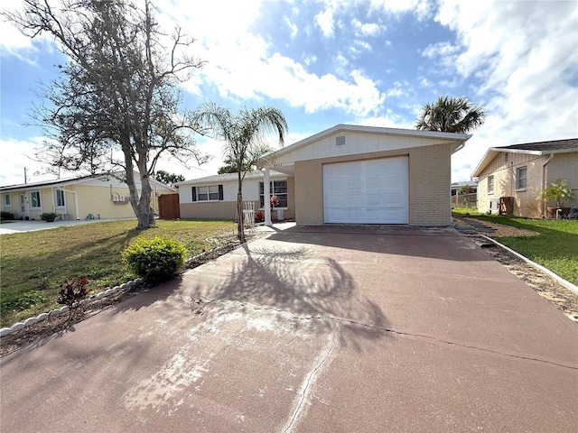 ranch-style house featuring a front lawn and a garage