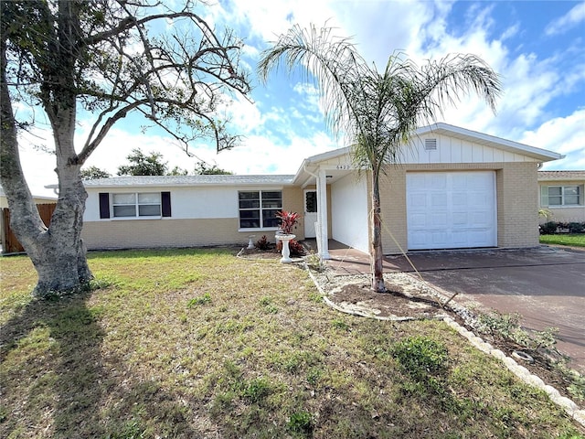 ranch-style home featuring a front lawn and a garage