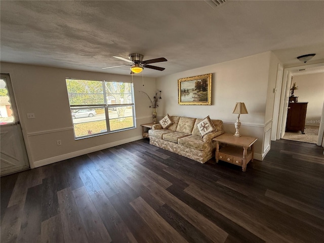 living room featuring ceiling fan and dark hardwood / wood-style flooring