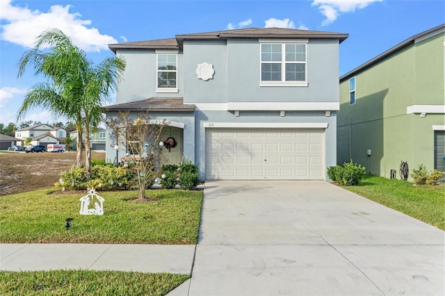 view of property with a garage and a front lawn